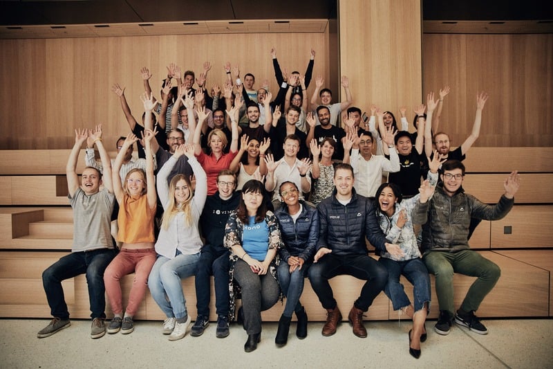 Crowd at an event with raised hands and warm light